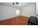 Bright living room with hardwood floors, white walls, and a ceiling fan with a light at 9377 Preston Rd, Brooksville, FL 34601
