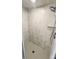 Modern bathroom shower featuring contemporary tile work, a rainfall shower head, and a built-in niche for toiletries at 9377 Preston Rd, Brooksville, FL 34601