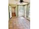 Enclosed sun room with lots of natural light, tile floor, and great views of the backyard at 9377 Preston Rd, Brooksville, FL 34601