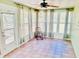 Bright sun room features a ceiling fan and many windows at 9377 Preston Rd, Brooksville, FL 34601
