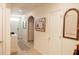 Spacious hallway featuring arched doorways and stylish decor, illuminated by natural light at 10029 Warm Stone St, Thonotosassa, FL 33592