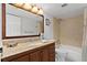 Bathroom featuring a granite countertop, dark wood cabinets, and a tub and shower combination at 10355 Paradise Blvd # 812, Treasure Island, FL 33706