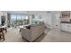 Inviting living room with plush seating and sliding glass doors opening to a balcony with water views at 10355 Paradise Blvd # 812, Treasure Island, FL 33706