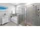 A stylish bathroom showcasing a soaking tub next to a tiled shower with glass doors and a rain shower head at 12503 Candleberry Cir, Tampa, FL 33635