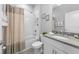 Neutrally decorated bathroom featuring shower-tub combo with a privacy curtain, single vanity and tile floors at 12503 Candleberry Cir, Tampa, FL 33635