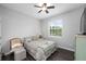 Comfortable bedroom featuring a window view, ceiling fan, hardwood floors and neutral wall paint at 12503 Candleberry Cir, Tampa, FL 33635
