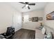 Cozy bedroom features a ceiling fan, hardwood floors, natural light and neutral wall paint at 12503 Candleberry Cir, Tampa, FL 33635