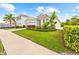 Beautiful single-story home with a well-manicured lawn, lush landscaping, and a convenient two-car garage at 12503 Candleberry Cir, Tampa, FL 33635