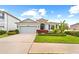 Charming single-story home featuring lush landscaping, a two-car garage, and a welcoming entrance at 12503 Candleberry Cir, Tampa, FL 33635