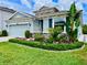 Charming home featuring lush landscaping, stone accents, and a well-maintained lawn, creating curb appeal at 12503 Candleberry Cir, Tampa, FL 33635