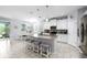 Bright and airy kitchen featuring a central island, stainless steel appliances, and an adjacent dining area at 12503 Candleberry Cir, Tampa, FL 33635