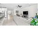 Spacious open concept with tile flooring, modern sofa, and an open view of the front entry at 12503 Candleberry Cir, Tampa, FL 33635