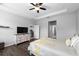 Spacious primary bedroom with tray ceilings, walk in closet, hardwood floors and an open doorway at 12503 Candleberry Cir, Tampa, FL 33635
