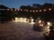 Paver patio with outdoor lighting, seating and firepit at 12503 Candleberry Cir, Tampa, FL 33635