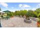 Paver patio with outdoor kitchen, seating, stone planters and firepit at 12503 Candleberry Cir, Tampa, FL 33635