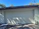 Two car attached garage with white paneled door at 13076 Kanawha Dr, Weeki Wachee, FL 34614