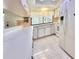 Bright kitchen with white cabinets, tile floors and backsplash, and a large window view at 13076 Kanawha Dr, Weeki Wachee, FL 34614