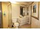 Cozy bathroom with a glass door shower, single sink vanity with a framed mirror, and a neutral color palette at 16209 Belle Meade Blvd, Odessa, FL 33556