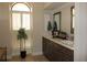 Bathroom featuring double sinks and a window with shutters at 16209 Belle Meade Blvd, Odessa, FL 33556