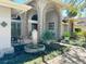 Inviting front entrance with brick archways, water feature, and elegant landscaping at 16209 Belle Meade Blvd, Odessa, FL 33556
