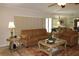 Comfortable living room with plush seating, a decorative rug, and ample natural light at 16209 Belle Meade Blvd, Odessa, FL 33556