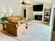Open concept living room with fireplace and large tv provides an inviting space for relaxation at 16209 Belle Meade Blvd, Odessa, FL 33556