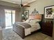 Spacious main bedroom offers comfort with its plush carpeting, ceiling fan, and private outdoor access at 16209 Belle Meade Blvd, Odessa, FL 33556