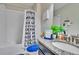 Bathroom featuring a single sink vanity with decor items, and toilet with shower and curtain at 16868 Scuba Crest St, Wimauma, FL 33598