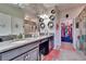 Spacious bathroom features granite countertops, dual sinks, mirrors, vanity, and walk-in closet at 16868 Scuba Crest St, Wimauma, FL 33598