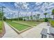 Well-manicured bocce ball courts with artificial turf and seating areas for relaxation and enjoyment at 16868 Scuba Crest St, Wimauma, FL 33598