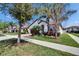Beautiful single-Gathering home with a paver driveway, stucco exterior, and mature landscaping at 16868 Scuba Crest St, Wimauma, FL 33598