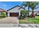 Charming home with a well maintained front yard, brick driveway, and a two-car garage at 16868 Scuba Crest St, Wimauma, FL 33598