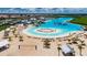 Stunning beach and turquoise lagoon view with slides, beach volleyball, cabanas and lounge chairs at 16868 Scuba Crest St, Wimauma, FL 33598