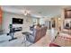 Bright and airy living area with a sectional sofa, access to the kitchen, and a view of the outside at 16868 Scuba Crest St, Wimauma, FL 33598