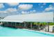 Modern poolside bar, with ample seating and open-air design and lagoon views at 16868 Scuba Crest St, Wimauma, FL 33598