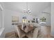 Dining room boasts a modern chandelier and an open layout connected to the kitchen with bar seating at 1801 Rudder Dr, Valrico, FL 33594
