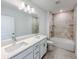 Modern bathroom with double sinks, large mirror, tub and shower combo at 22442 Peachland Blvd, Port Charlotte, FL 33954
