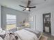 Well-lit bedroom with modern decor, including a sleek dresser and an organized closet at 22442 Peachland Blvd, Port Charlotte, FL 33954
