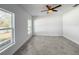 Bright bedroom features tile floors, a ceiling fan, and two windows at 22442 Peachland Blvd, Port Charlotte, FL 33954