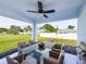 Spacious covered patio with outdoor dining set and barbecue grill overlooking the landscaped backyard at 22442 Peachland Blvd, Port Charlotte, FL 33954