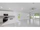 Bright, open-concept kitchen with white cabinets, modern appliances, and an island at 22442 Peachland Blvd, Port Charlotte, FL 33954
