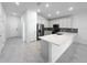 Bright, open-concept kitchen featuring large island, white cabinets and stainless steel appliances at 22442 Peachland Blvd, Port Charlotte, FL 33954