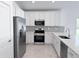 Modern kitchen featuring stainless steel appliances, white cabinets and a tile backsplash at 22442 Peachland Blvd, Port Charlotte, FL 33954