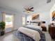 Comfortable main bedroom features natural light, ceiling fan, and neutral decor at 22442 Peachland Blvd, Port Charlotte, FL 33954
