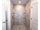 Nicely tiled shower stall featuring glass shelves at 22442 Peachland Blvd, Port Charlotte, FL 33954