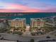 Stunning aerial view of waterfront condo buildings with a community pool and beach views at 240 108Th Ave # 102, Treasure Island, FL 33706