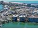 Aerial view of the condominium complex with a pool and dock overlooking the intercoastal waterway at 240 108Th Ave # 102, Treasure Island, FL 33706