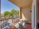 Inviting balcony seating area with a colorful rug and a view of palm trees at 240 108Th Ave # 102, Treasure Island, FL 33706
