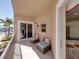Cozy balcony with outdoor seating offering partial views of the street and palm trees at 240 108Th Ave # 102, Treasure Island, FL 33706
