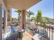 Inviting balcony seating area with a colorful rug and a view of palm trees at 240 108Th Ave # 102, Treasure Island, FL 33706